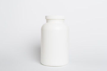 Plastic bottle for vitamins on color background