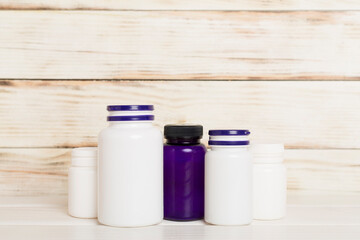 Plastic bottles for vitamins on wooden table