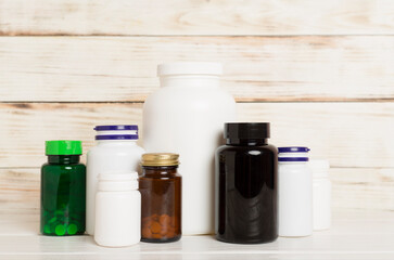 Plastic bottles for vitamins on wooden table