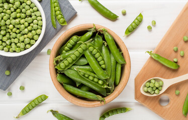 Composition with fresh green peas on wooden background, top view