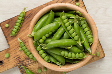 Composition with fresh green peas on wooden background, top view