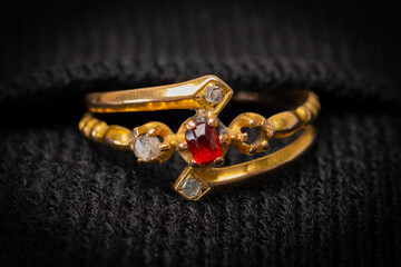 Antique ladies engagement or wedding ring with a four white diamond cluster and a red ruby type...