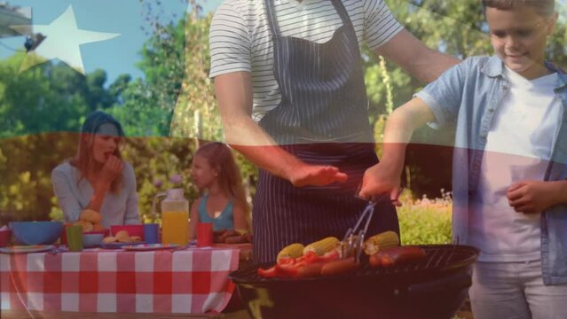 Animation of flag of chile waving over caucasian father teaching son to place food on barbeque