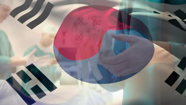 Animation of south korea flag waving over diverse surgeons wearing gloves before surgery in hospital