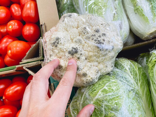 Tainted cauliflower. Black mold on bad cauliflower. Improper storage of vegetables.