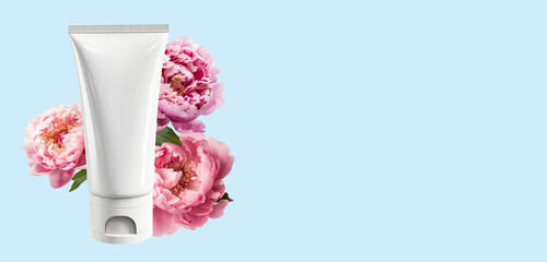 Mock-up of white squeeze bottle plastic tube and pastel pink peony. Natural organic cosmetics concept. Banner, Flat lay, top view, copy space.