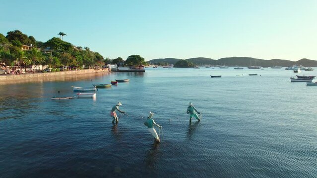 Drone flyover the Three Fishermen monument in Arma&ccedil;ao de B&uacute;zios, Brazil