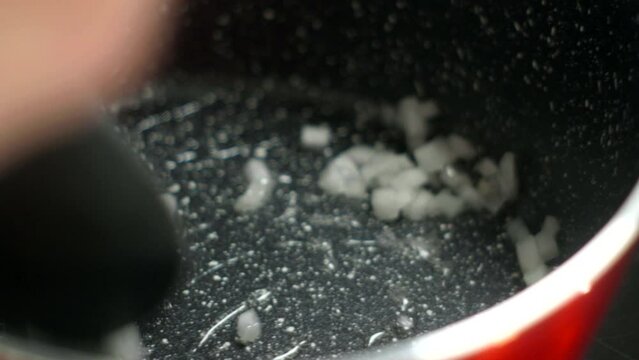 Detail shot, saucepan saut&eacute;ing white onion