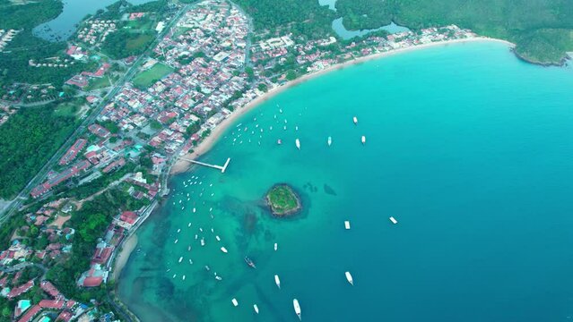 Wide topdown view of Praia do Canto and Caboclo islet, turquoise water bay in Buzios