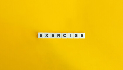 Exercise Word on Block Letter Tiles on Yellow Background. Minimal Aesthetic.