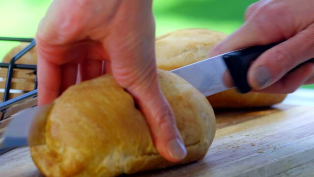 Detail shot, cutting baguette bread.