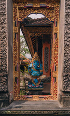 Sculpture of blue Lord Ganesha in balinese temple. Indonesian hindu god, symbol of happiness and...