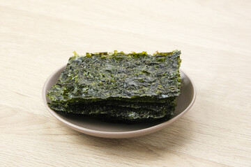 Korean Seaweed, salted nori laver sheet on a plate 

