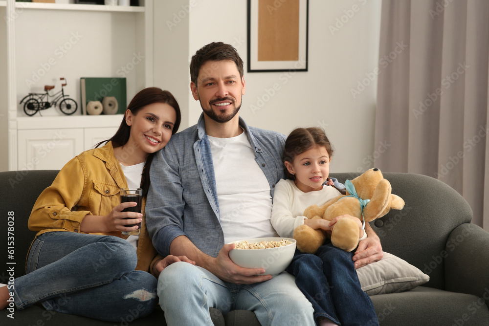 Sticker Happy family watching TV on sofa at home