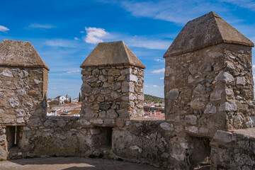 Stone walls of Serpa castle with church in background, Alentejo PORTUGAL