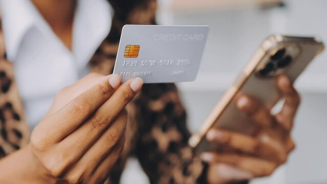 Women holding credit card and using smartphones at home.Online shopping, internet banking, store online, payment, spending money, e-commerce payment at the store, credit card, concept