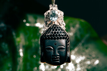 Stone pendant with the face of the buddha
