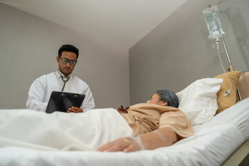 Doctors check patient outcomes in the recovery room after treatment.