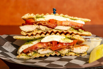 Grilled chicken sandwich with tomato and mozzarella