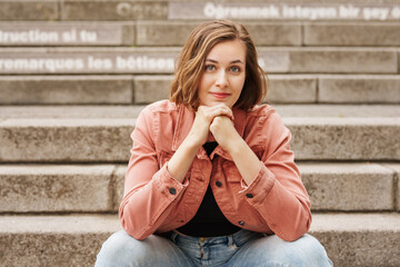 Young woman sitting on stairs in the city