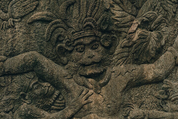 Ancient stone wall carved in sacred monkey forest. Traditional monkey sculpture in ubud sanctuary © Flash Vector
