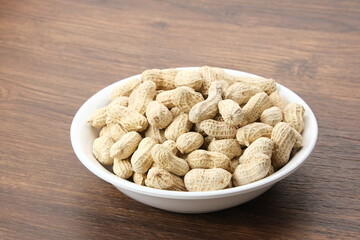 Roasted peanuts on small bowl. Copy space
