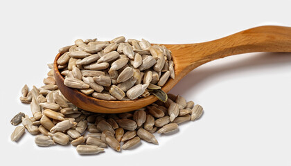 Natural shelled sunflower seeds in wooden spoon over white background