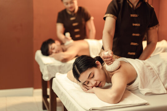 Relaxation Asian woman customer get service Thai herbal compress massage in beauty spa centre. Body care.
