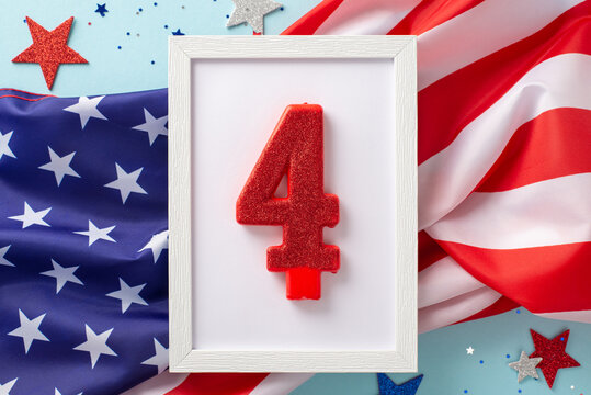 US Independence Day concept. Top view photo of wooden frame with the number 4 surrounded by blue, white and red glitter stars and american flag on celeste isolated background