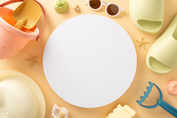 Tropical getaway with baby essentials: top view beach toys, sandcastle set, sunglasses, sunhat, rubber slippers, seashells, starfish on soft beige backdrop, offering circular space for text or advert