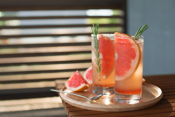 Paloma cocktails on summer terrace with copy space. Tequila blanco, syrup, grapefruit juice and...