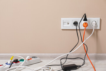 Extension cord with power plugs in sockets indoors, space for text