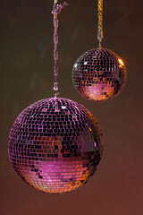 Shiny bright disco balls under color lights