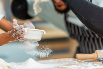 african afro black daughter kids sifting flour powder and sprinkling ingredients on massaging dough for bakery cooking. Black african daughter afro hair enjoy sifting flour wheat by sieve in kitchen