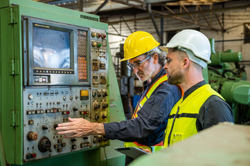 Two professional engineer worker technician assistant in helmet inspection check old machine construction factory with colleague manager. check old machinery production construction operating