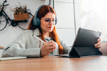 Redhead Girl. Red-haired Professional Harnesses Creativity and Focus in Café-based Work