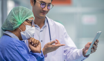 Two senior doctor hold clipboard document file of patient record talking discussion about treatment...