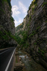 Amazing curved road between the mountains. Wide angle landscape photo with the road from Bicaz Gorges (Cheile Bicazului in Romanian language) landmark in Transylvania and Moldova.