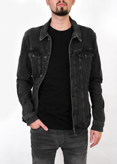 portrait of a man in a black denim jacket and black jeans on a white background