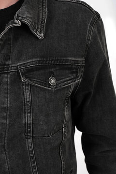 pocket on a black denim jacket close-up