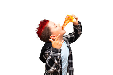 A cute stylish baby boy with a red mohawk on his head is biting a big juicy piece of triangle sausage pizza near his open mouth and showing a rock and roll hand sign. - 615408663