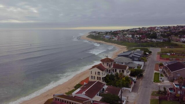South Africa drone aerial Jeffreys Bay surf town stunning early morning sunrise golden sun on ocean surfer wave groundswell Sunrise sunset drone JBay stunning coastline beach cinematic upward motion