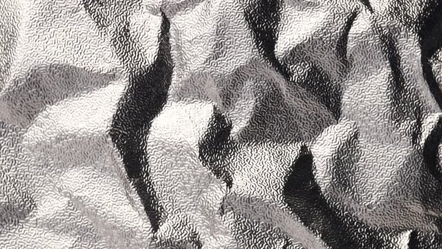  corrugated foil, rotation in circle. silver texture background Turning. selective focus