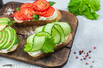 Sandwiches with tomato, avocado and cucumber