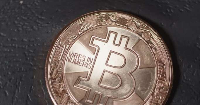 BTC coin rotating on table close up. The main coin in crypto industry bitcoin shown as coin that rotates