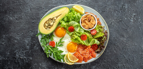 Healthy eating food vegetables salad, avocado, fish, eggs, nuts peanut paste. low carb keto ketogenic diet