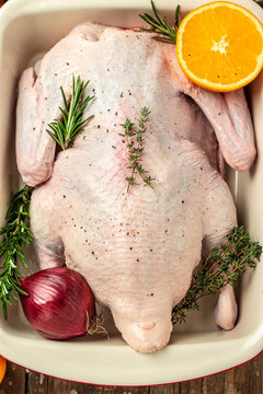 Fresh raw whole duck ready for cooking on a wooden background, Culinary cooking. banner, menu, recipe place for text, top view