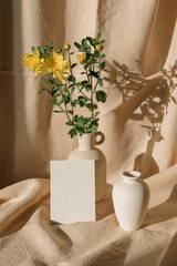 Blank paper mockup. Still life with empty card, ceramic vase, candle, linen. Showcase  of designs in an aesthetic setting.