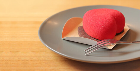 Pink heart shaped cake. Dessert for Valentine's Day. Cake in a cafe. Сopy space