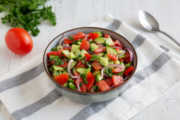 Homemade Mediterranean Cucumber Tomato Salad in a Bowl, side view.